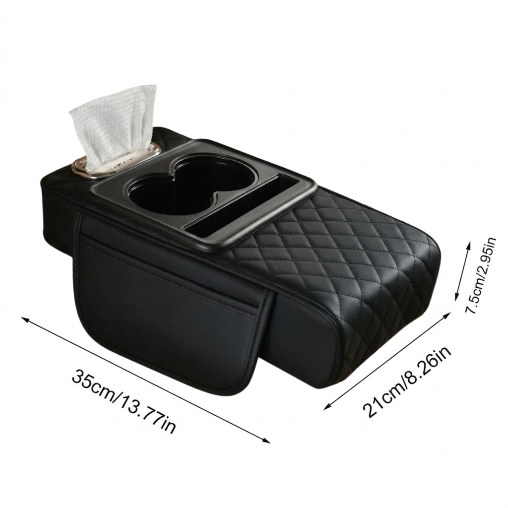 Product image showing the dimensions and features of a black quilted leather car console armrest cushion, including an integrated tissue dispenser, dual cup holders, a smartphone tray, and an attached side storage pocket. Measurements are detailed at 35cm (13.77in) long, 21cm (8.26in) wide, and 7.5cm (2.95in) high.