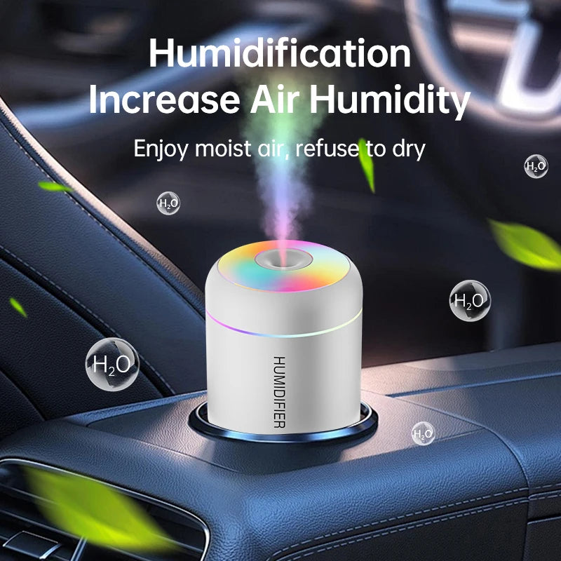 Pearl white car air humidifier operating securely inside a standard vehicle cup holder, discharging mist into the cabin interior.