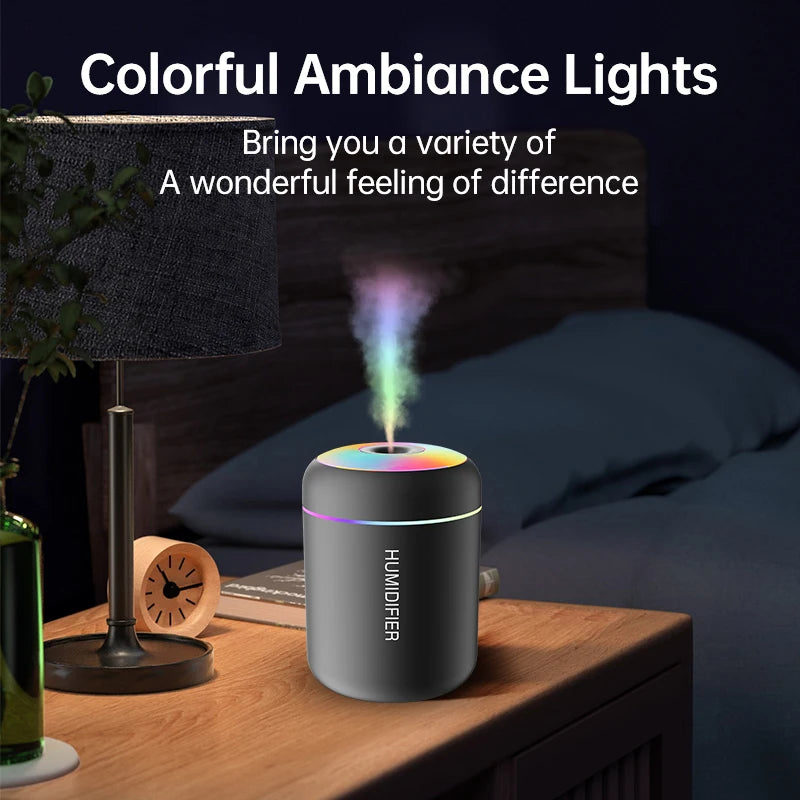 Stealth black car humidifier operating in a low-light room setting, displaying the integrated multi-colour LED ambient lighting ring.