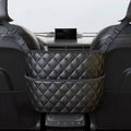 Black quilted PU leather console storage bag installed between front car seats holding a bottle and handbag