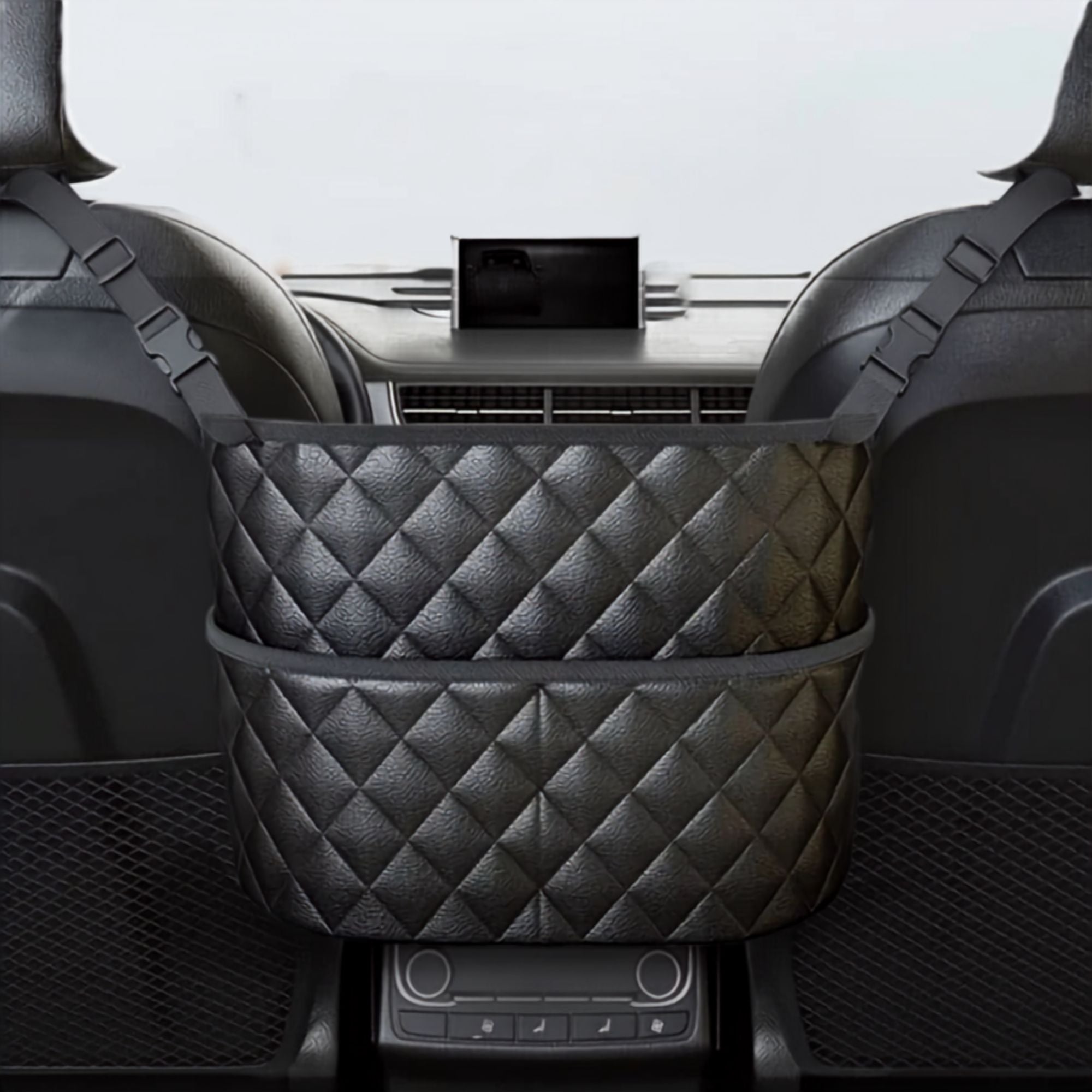 Black quilted PU leather console storage bag installed between front car seats holding a bottle and handbag