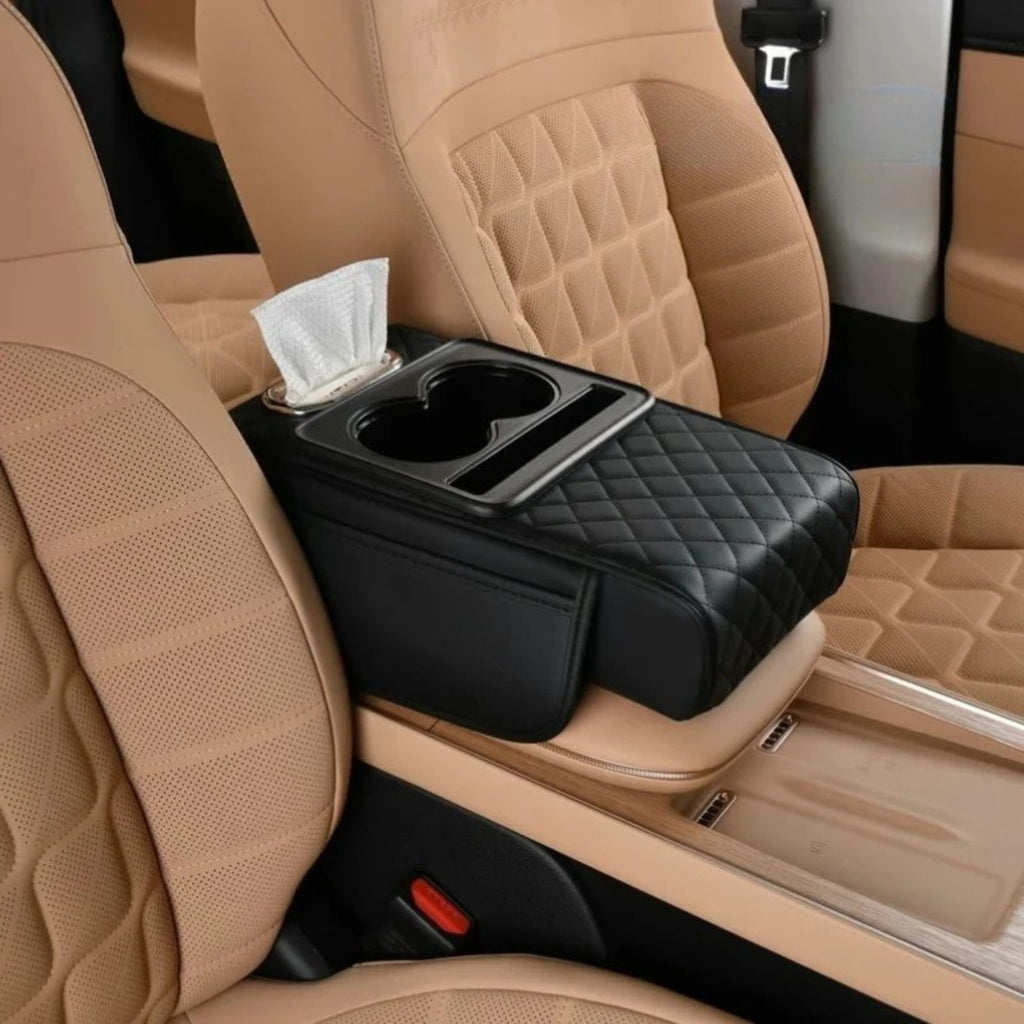 All-black centre console armrest cushion installed between the front seats of a vehicle featuring tan interior upholstery.