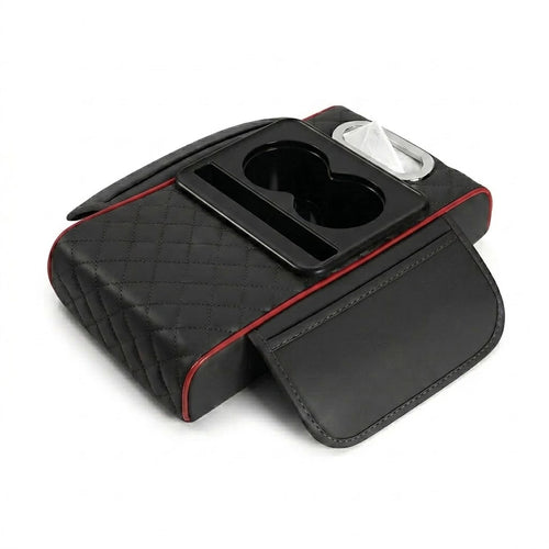 Black centre console armrest cushion with red stitching trim, displaying the dual cup holders and tissue dispenser slot.
