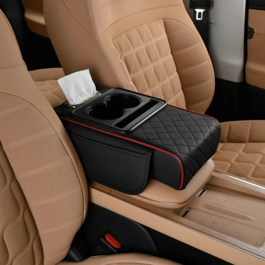 Black centre console armrest cushion with red stitching trim installed empty on a vehicle's centre console.