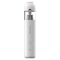 Upright white cordless handheld car vacuum cleaner featuring a single-button interface and a transparent dust receptacle.