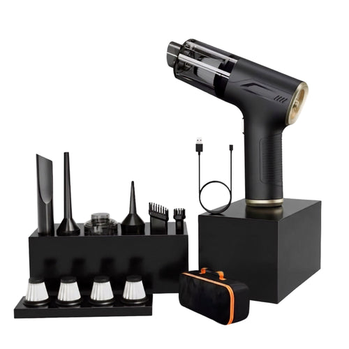 Black handheld hair styler styling tool with gold trim, shown with multiple attachment nozzles in a black stand, a USB charging cable, and a black carrying case with orange accents on a white background.