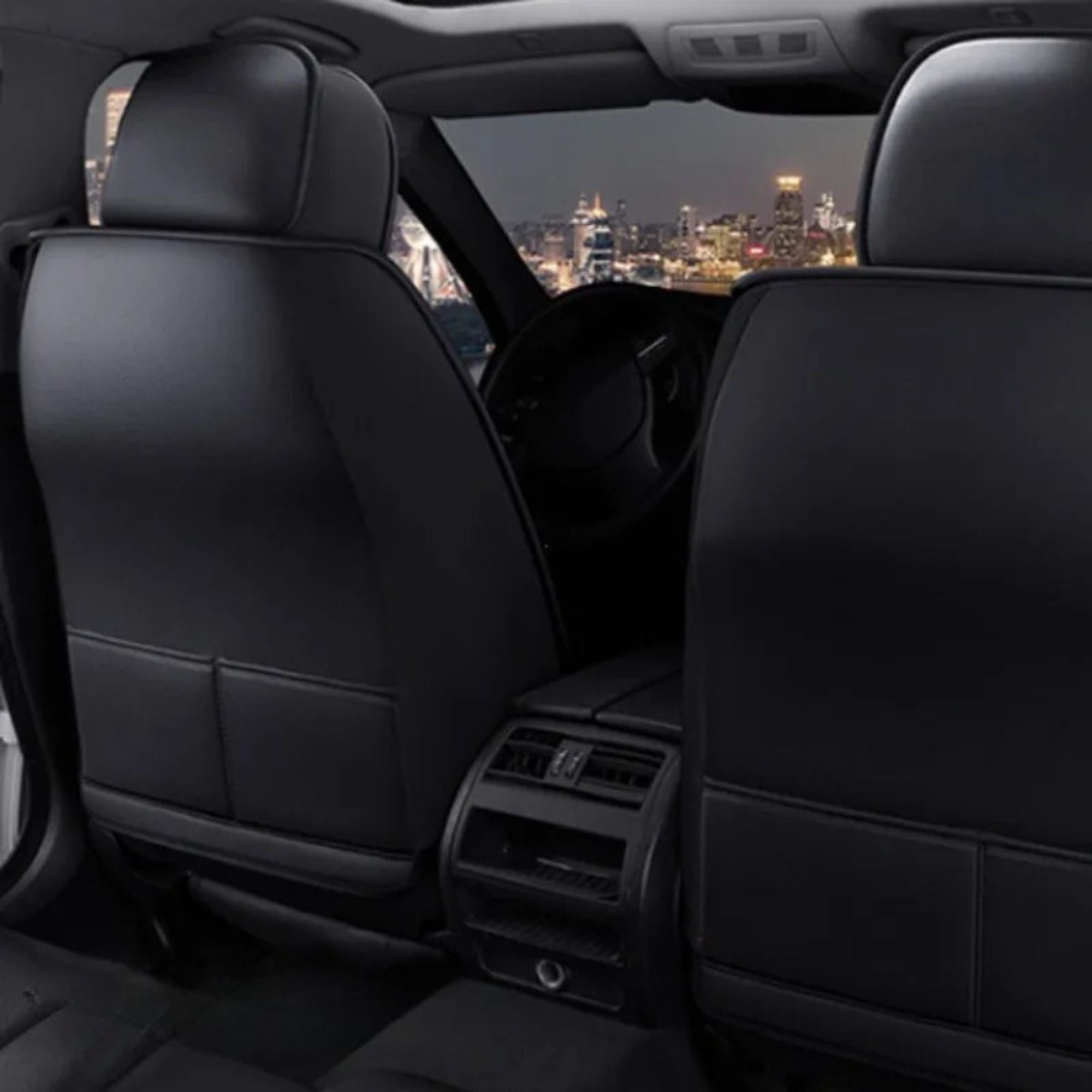 PU Leather Seat Covers fitted in a car interior at night with city lights in the background