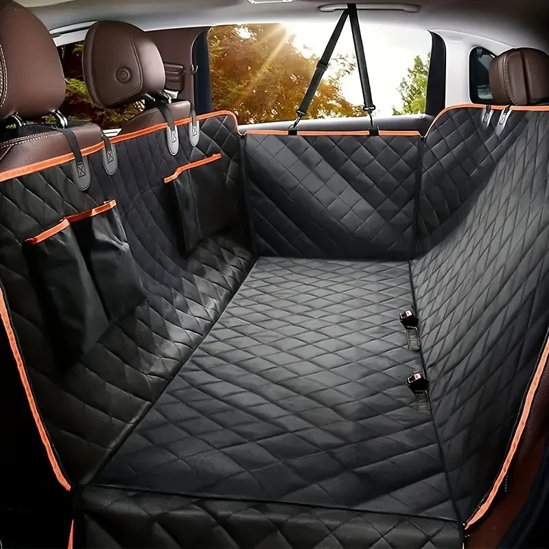 Black quilted dog backseat protector hammock installed in a vehicle, displaying the fully enclosed design across the rear passenger seats.