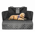 Quilted black dog car seat cover and interior boot liner installed in a vehicle cargo area with a golden retriever resting on it.