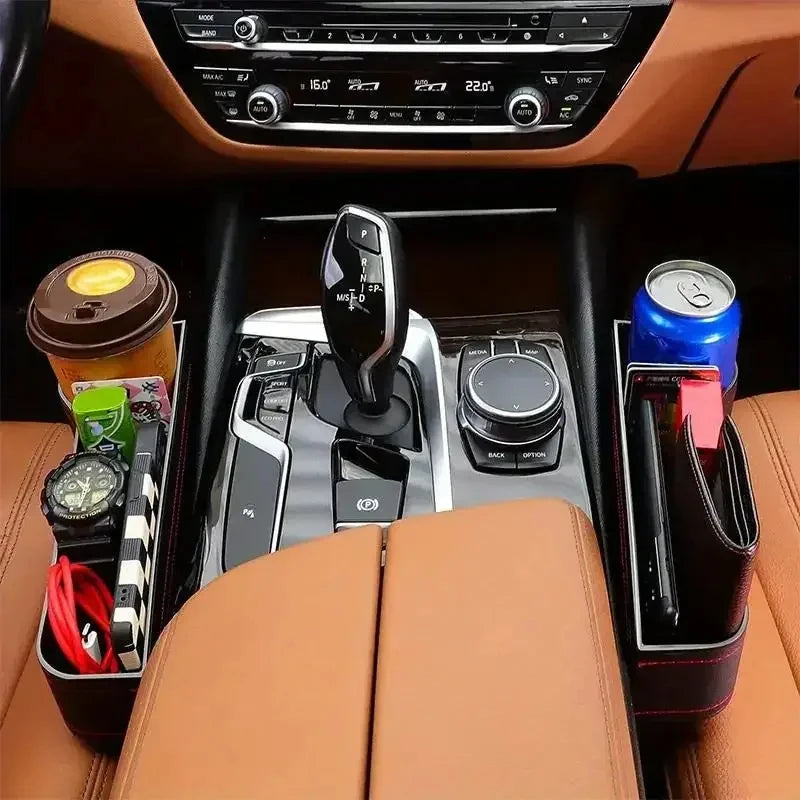 Two black PU leather car seat gap organisers installed on either side of a centre console, holding drinks, phones, and daily essentials.