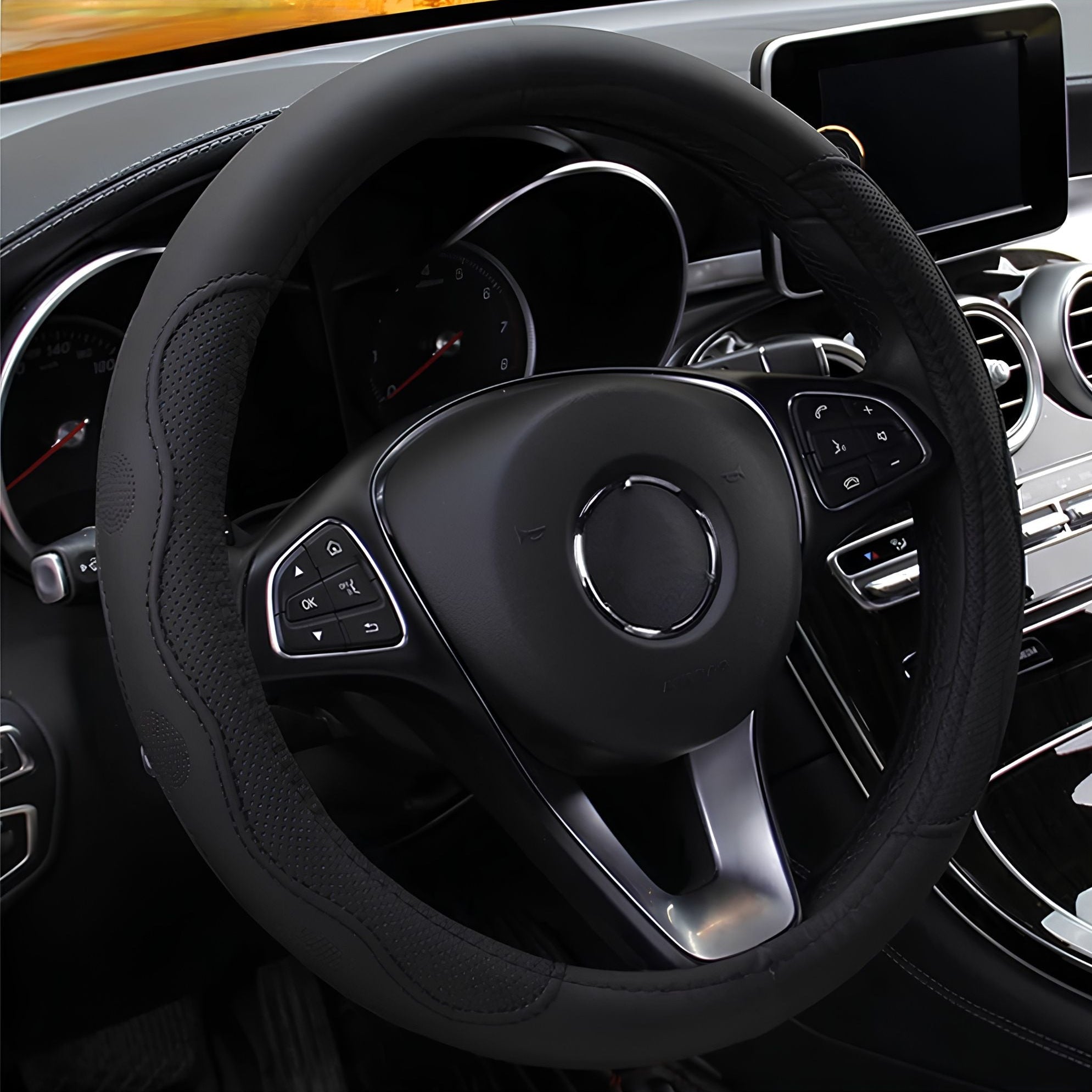 All-black embossed PU leather steering wheel cover installed on a steering wheel inside a modern vehicle cabin.