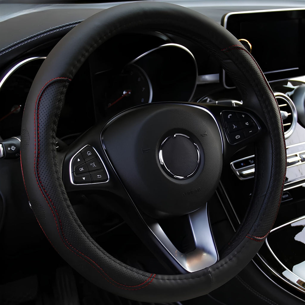 Black embossed PU leather steering wheel cover featuring red stitching trim installed on a steering wheel inside a vehicle cabin.