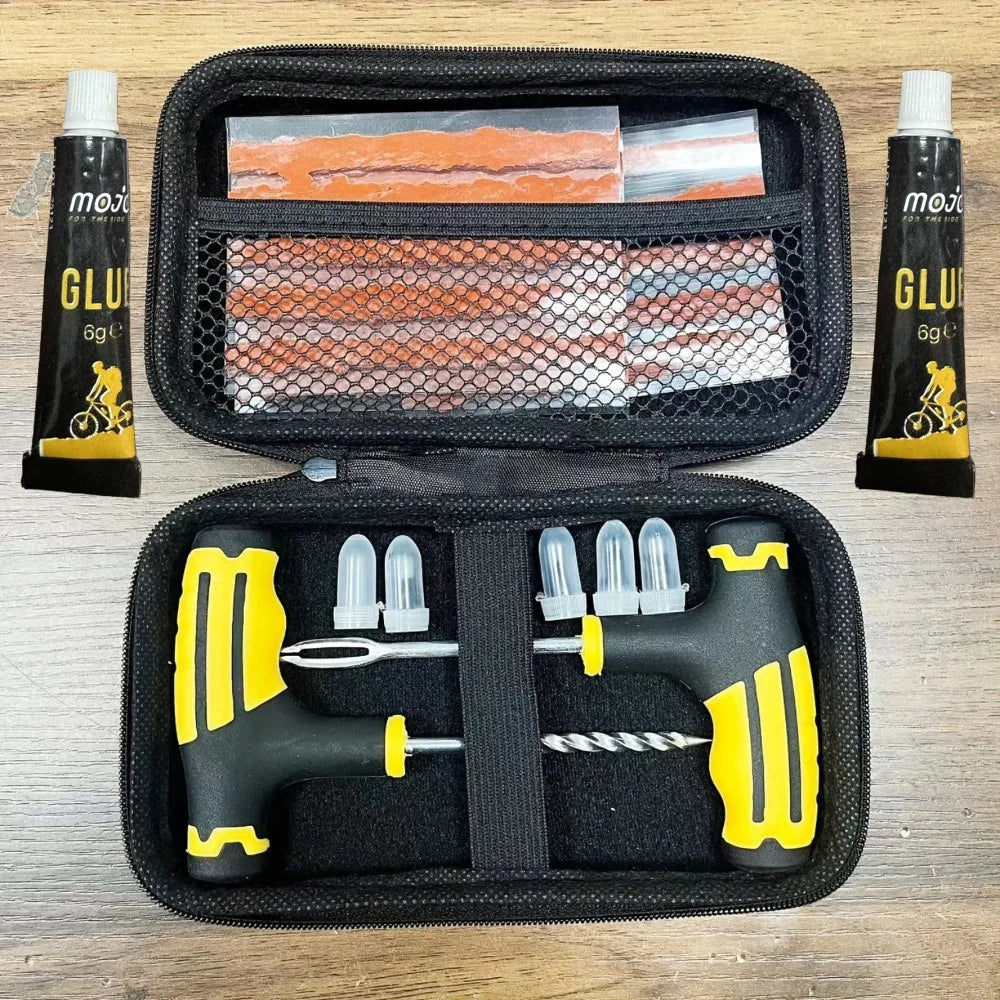 Open zippered storage case displaying the organised T-handle reamer, plugger tools, and rubber strips secured within internal mesh compartments and elastic loops.