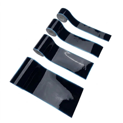 Four rolls of glossy black adhesive tape arranged diagonally on a plain white background.