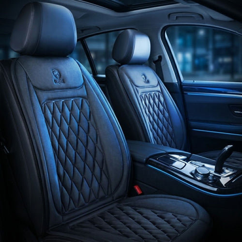 Custom black heated car seat covers with diamond-quilted stitching and a small embroidered logo on the headrests, shown installed on the front seats of a luxury vehicle interior.