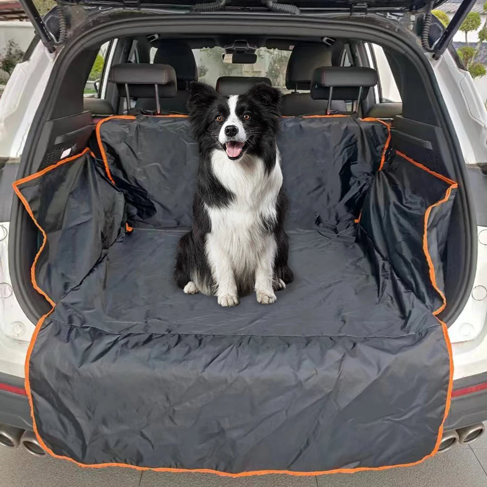 Border Collie sitting securely inside a black heavy-duty pet cargo protector installed in the boot of an SUV.