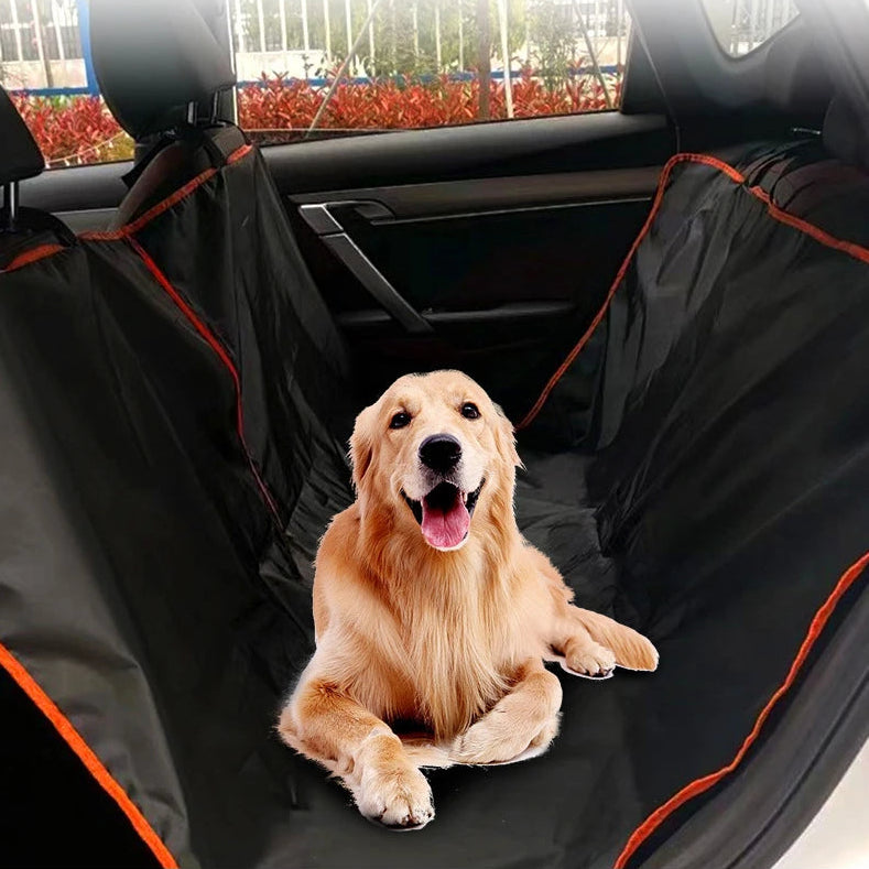 Golden Retriever sitting securely inside a black Oxford fabric dog backseat hammock installed in a passenger vehicle.