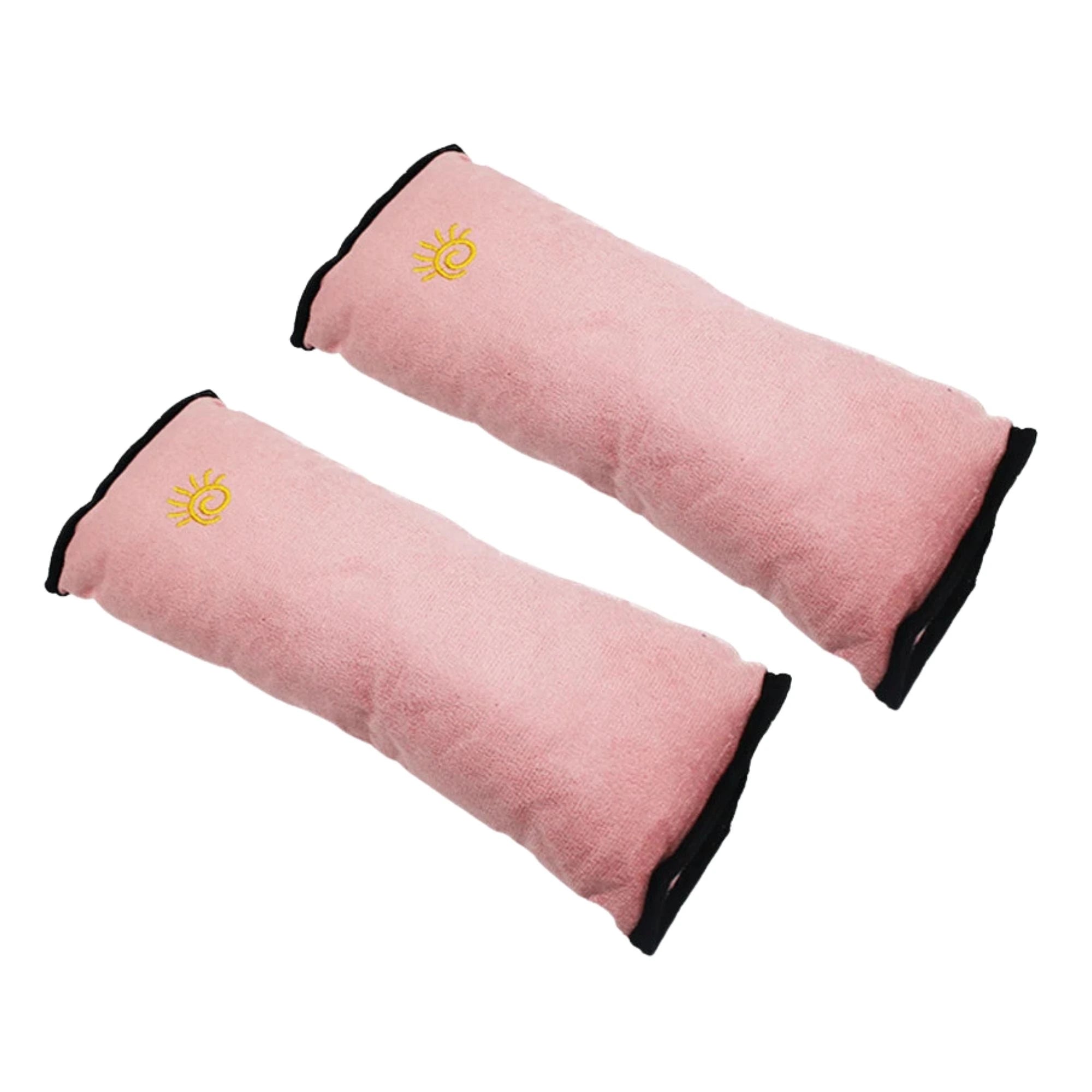 Soft pink kids seat belt shoulder pads displayed on a white background.
