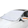 A silver magnetic car windscreen cover and snow shield installed on a white vehicle, featuring side mirror covers with high-visibility orange reflective strips.