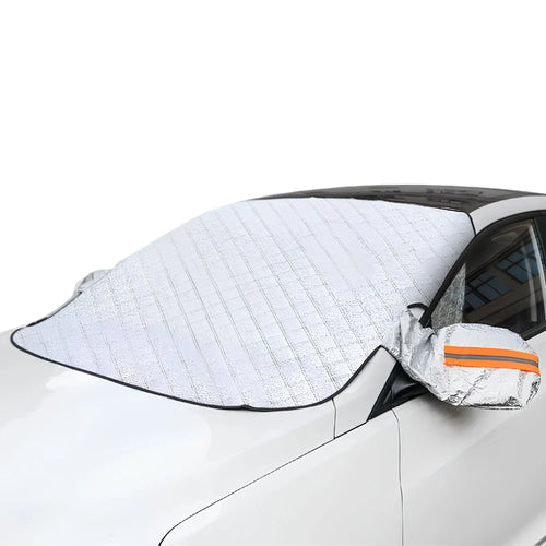 A silver magnetic car windscreen cover and snow shield installed on a white vehicle, featuring side mirror covers with high-visibility orange reflective strips.