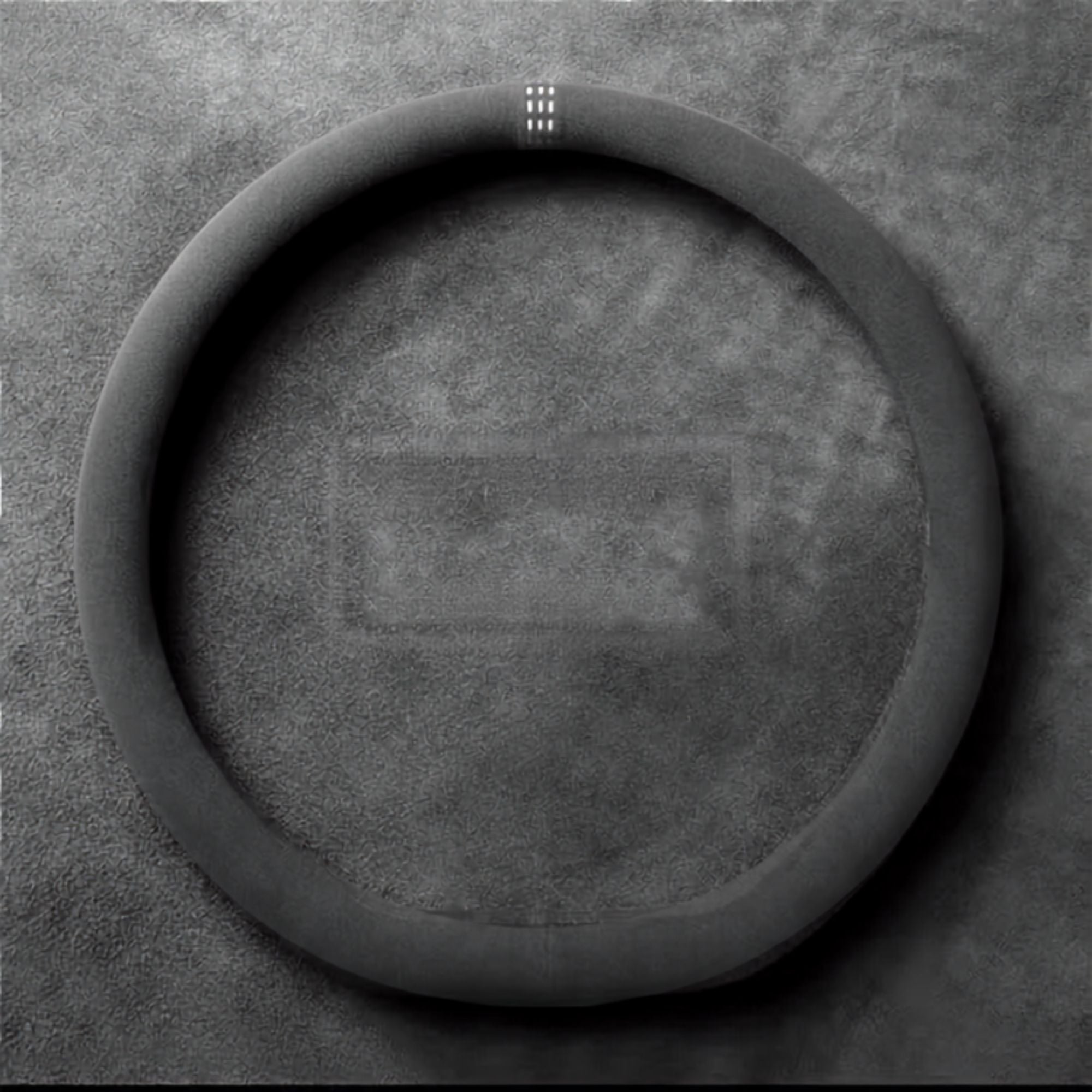 Flat-bottom Steering Wheel Cover and Non-Slip Suede Grip Cover in black suede with white stitching, laid flat to show the D-shaped fit.