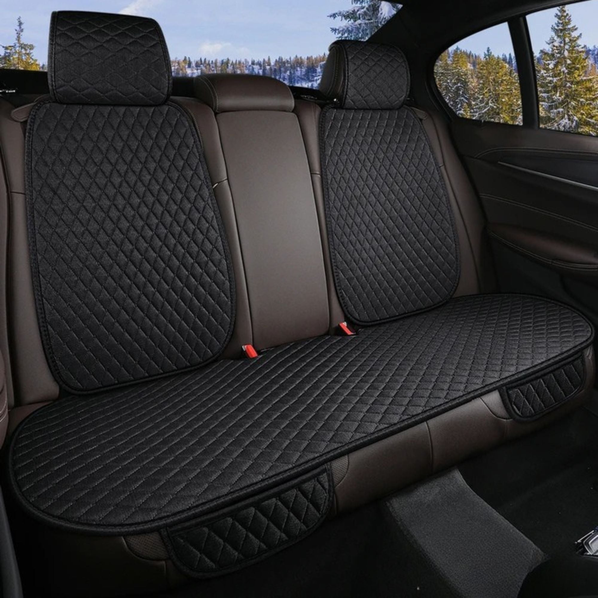 Black diamond-quilted linen rear bench seat cover installed securely in the back of a vehicle.