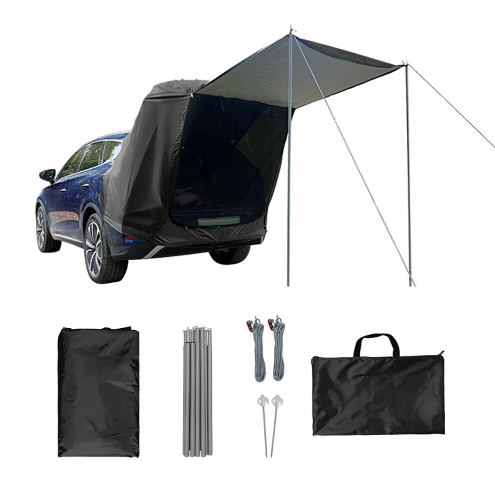 Stealth black waterproof car boot extension tent displayed with included aluminium support poles, wind ropes, ground stakes, and storage bag.