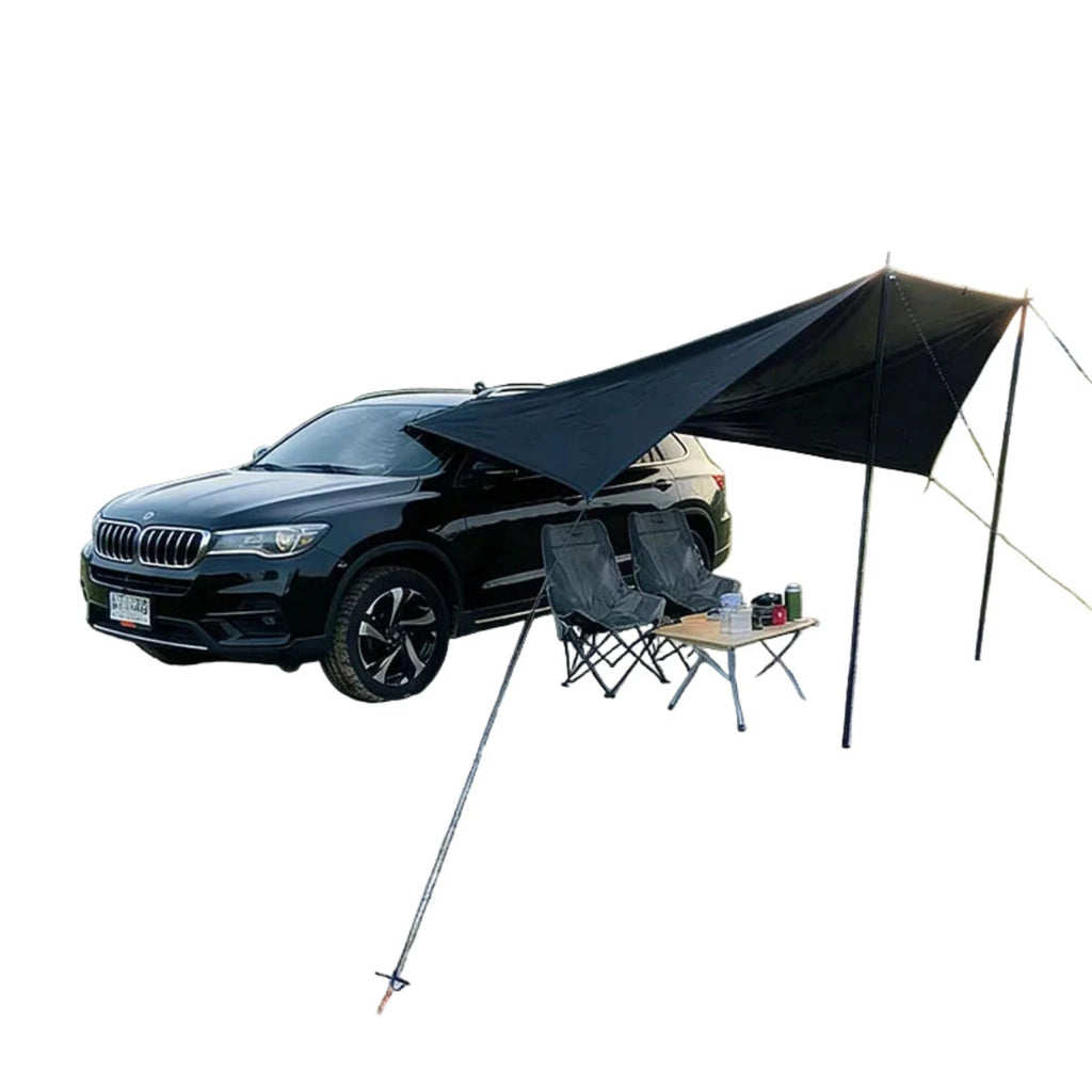 Black waterproof car side awning tent set up on a vehicle, supported by two poles and secured with guy ropes.