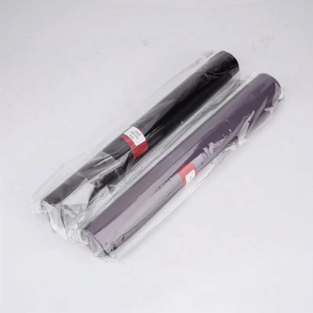 Two rolls of craft vinyl wrap, one black and one dark purple, sealed in clear plastic packaging with red and white labels, on a white background.
